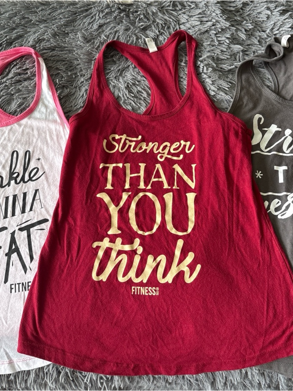 3 Racerback Tank Tops with Motivational Script and one sleeveless hooded tank